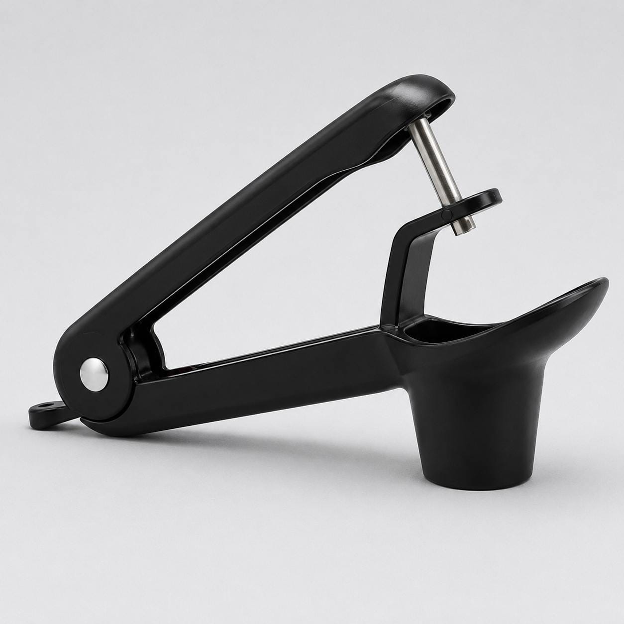 UCMORX-style black handheld cherry pitter on a plain background