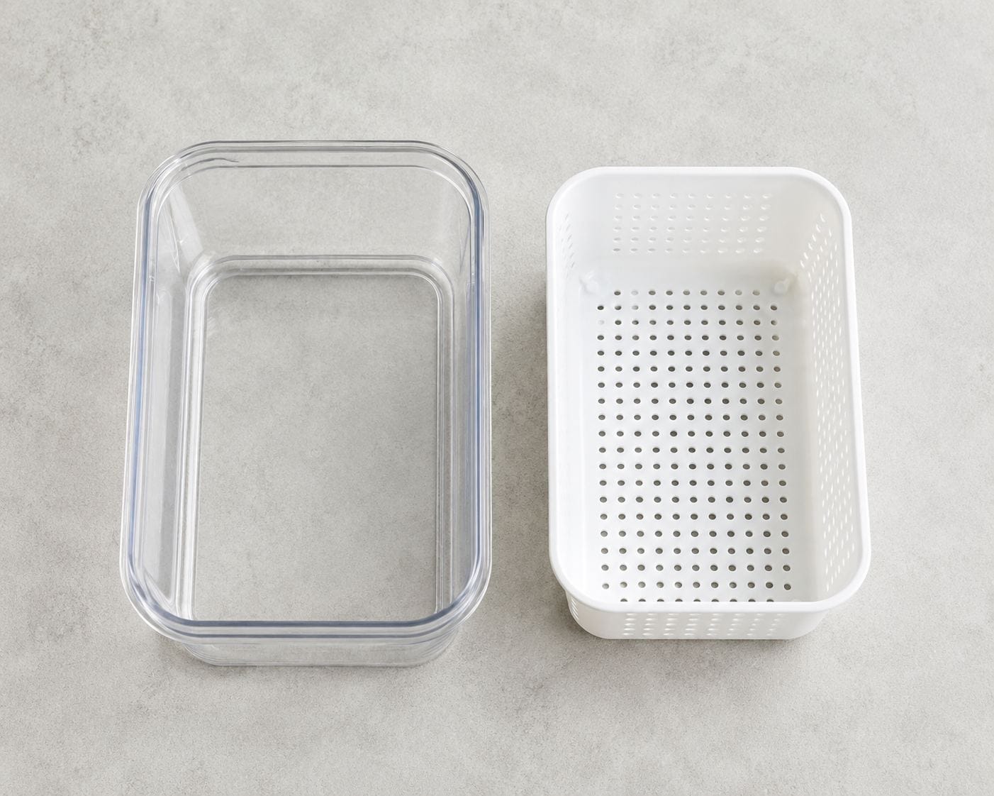 Fruit storage container base and removable colander insert shown separately, demonstrating the two-piece drainage design
